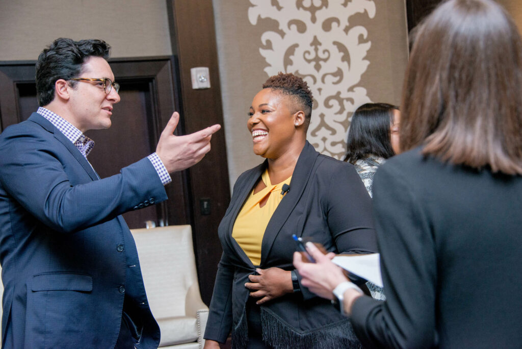 Man and woman talking in a corporate space about B2B sales training.